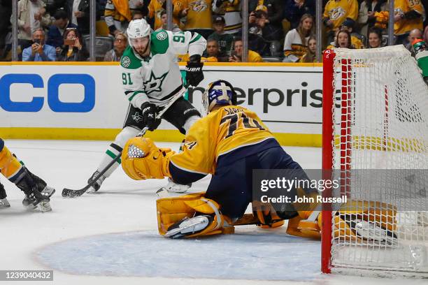 Juuse Saros of the Nashville Predators makes a save against Tyler Seguin of the Dallas Starsduring the third period at Bridgestone Arena on March 08,...