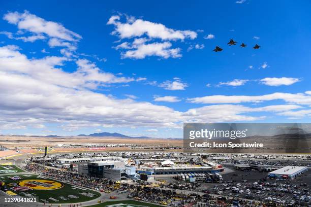 Air Force Heritage Flight made up of an F-16, an F-35, an F-22, and an F-15 makes a flyover before the Pennzoil 400 presented by Jiffy Lube NASCAR...