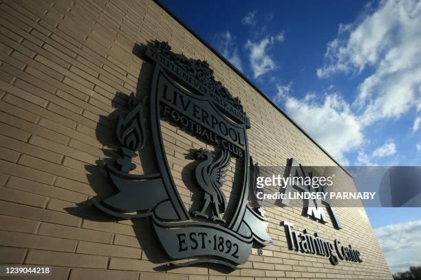 Photograph taken on March 7, 2022 shows the logo and the motto of Liverpool football team displayed at their training ground in Liverpool, north west...