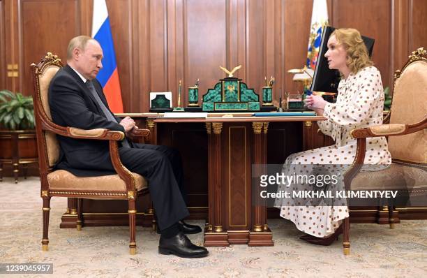Russian President Vladimir Putin meets with Commissioner for Children's Rights Maria Lvova-Belova at the Kremlin in Moscow on March 9, 2022.