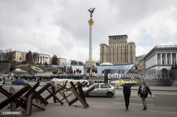 Ukrainians wave flags during the live performance of Kyiv Symphony Orchestra at Independence Square, where the sound of sirens that herald the...
