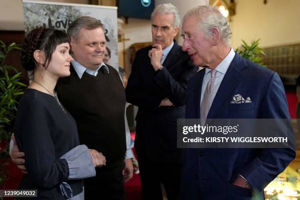 Britain's Prince Charles, Prince of Wales meets with meets Ukraine born Andriy Kopylash, second left, and his daughter Veronika Kopylash, who escaped...