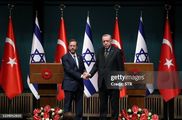 Israeli President Isaac Herzog and his Turkish counterpart Tayyip Erdogan shake hands during a press conference in Ankara, on March 9, 2022.