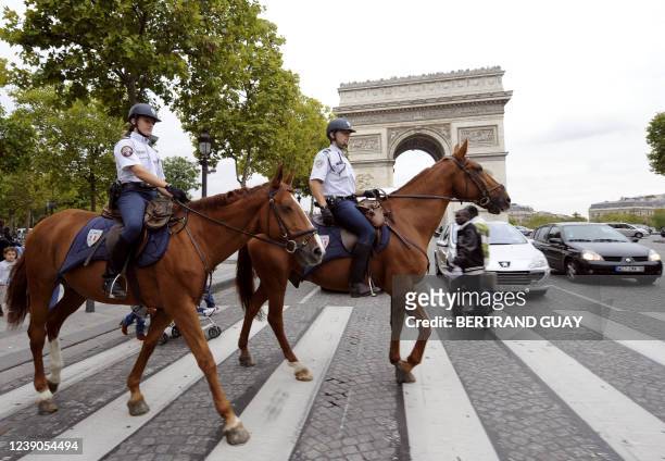 French mounted policemen patrol on October 4, 2010 on the Champs Elysees avenue in Paris. France said on October 3 that it was staying vigilant and...
