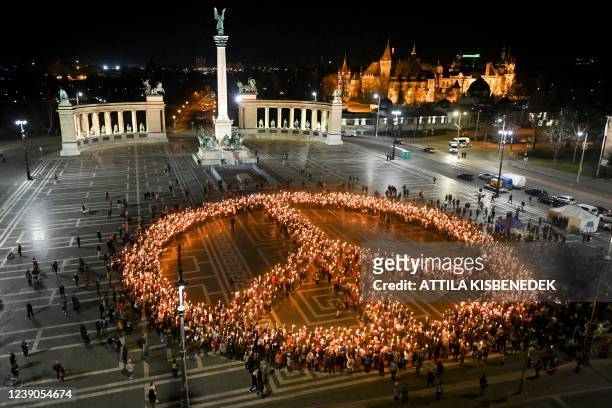 Protestors against the war and Russian invasion of Ukraine form the peace symbol during a demonstration at Heroes' Square in central Budapest, on...