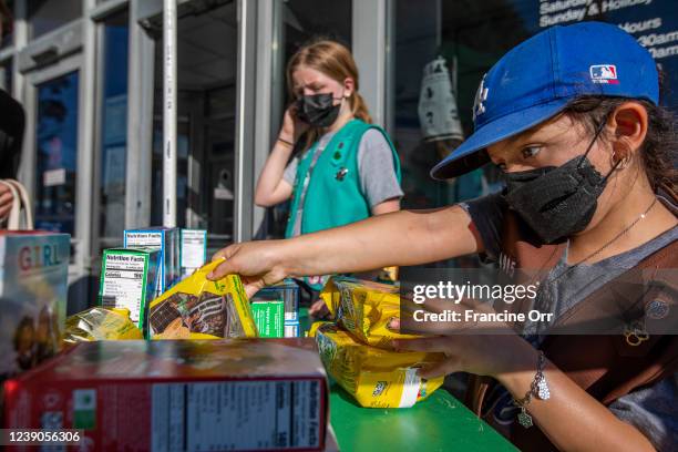 Madar Mee left, and Emma Diaz right, are selling Girl Scout Cookies in the Mar Vista neighborhood at on Friday, Feb. 11, 2022 in Los Angeles, CA....