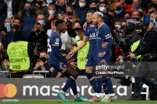 Kylian Mbappe of PSG celebrates after scoring his sides first goal during the UEFA Champions League Round Of Sixteen Leg Two match between Real...