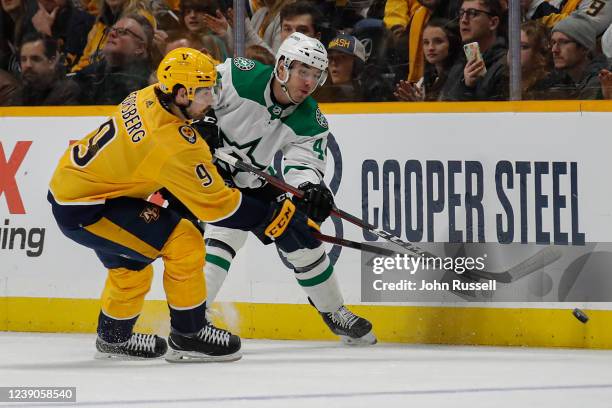 Filip Forsberg of the Nashville Predators ties up Joel Hanley of the Dallas Stars at Bridgestone Arena on March 08, 2022 in Nashville, Tennessee.