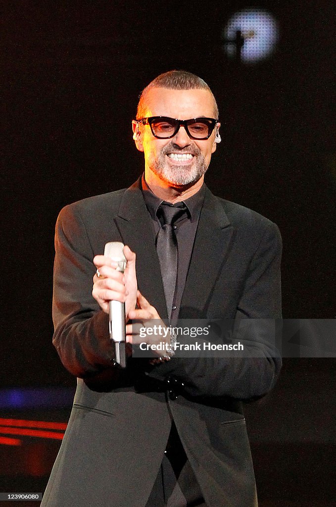 George Michael Instruments British singer George Michael performs live during a concert at the ...