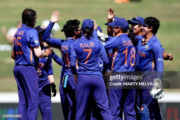 Indian players celebrate the dismissal of New Zealand's Suzie Bates during the 2022 Women's Cricket World Cup match between New Zealand and India at...