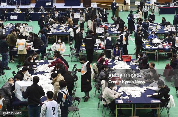 Election officials wearing masks for protection against the coronavirus count votes in Seoul for South Korea's presidential election on March 9, 2022.