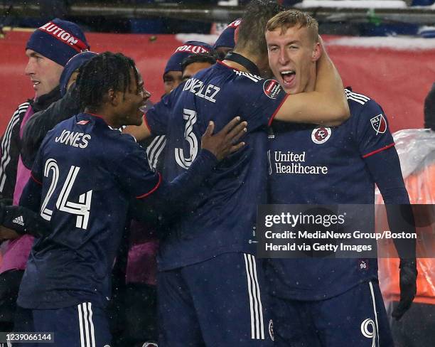 DeJuan Jones and Omar Gonzalez of New England Revolution congratulate Adam Buksa after scoring during the second half of the Concacaf Champions...