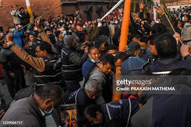 Devotees take part in a ritual to mark the beginning of Holi, the spring festival of colours, at Basantapur Durbar Square in Kathmandu on March 10,...