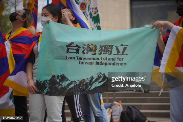 People holding a banner asking for the Taiwanese independence during a protest to commemorate the 63rd Anniversary of 310 Anti-Violence Day in Tibet,...