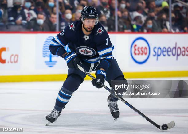 Brenden Dillon of the Winnipeg Jets plays the puck during second period action against the Dallas Stars at Canada Life Centre on March 04, 2022 in...