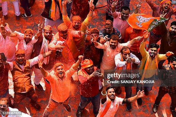 Supporters of India's Bharatiya Janata Party celebrate outside the party office in Lucknow on March 10 on the day of counting of votes for the Uttar...