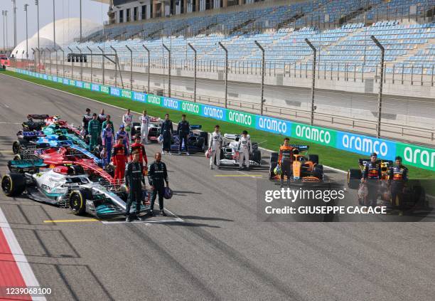 Drivers pose on the starting grid during the first day of Formula One pre-season testing at the Bahrain International Circuit in the city of Sakhir...