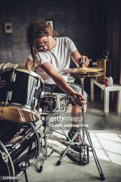 teenager playing rock and roll at home - singer drummer stock pictures, royalty-free photos & images
