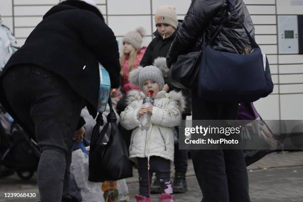 Refugees exit a bus arriving at the refugee camp ''Tesco'' or ''Industry'' of Przemysl, southeastern Poland, on March 3, 2022. More than one million...