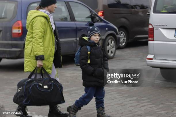 Refugees exit a bus arriving at the refugee camp ''Tesco'' or ''Industry'' of Przemysl, southeastern Poland, on March 3, 2022. More than one million...