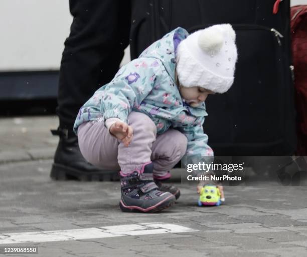 Refugees exit a bus arriving at the refugee camp ''Tesco'' or ''Industry'' of Przemysl, southeastern Poland, on March 3, 2022. More than one million...