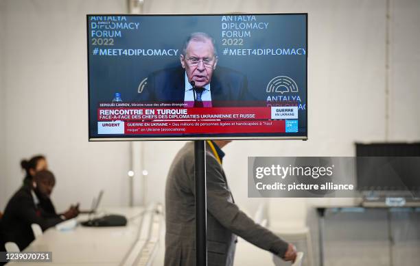 March 2022, France, Versailles: A television in the press center at the chateau in Versailles shows the broadcast of the press conference of Sergei...