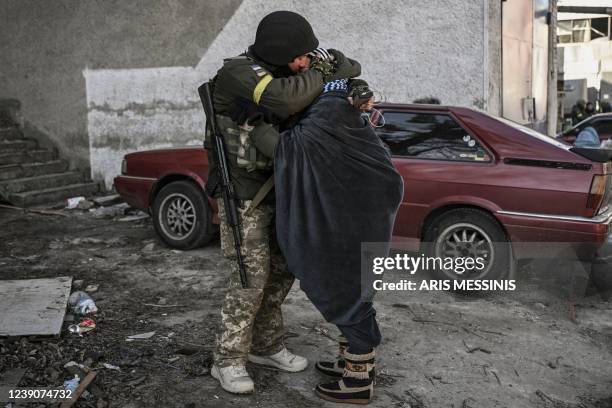 Ukranian soldier hugs his wife in the city of Irpin, north of Kyiv, on March 10, 2022. - Russian forces on March 10, 2022 rolled their armoured...