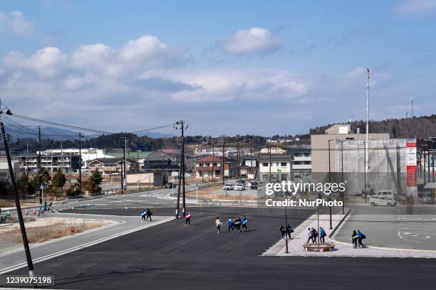Local students walk in front of the newly Tomioka station in Fukushima prefecture on Mar 10, 2022.