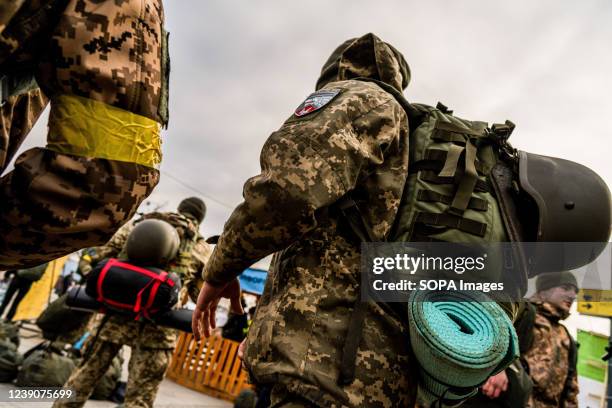 Soldiers carry their bags on their backs in Lviv train station. As Russia launched a full-scale invasion of Ukraine, people tried to escape the...