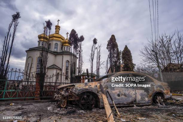 Burnt out car and a damaged church caused by the Russian military attack seen near the town. The Ukrainian military continue their evacuation mission...