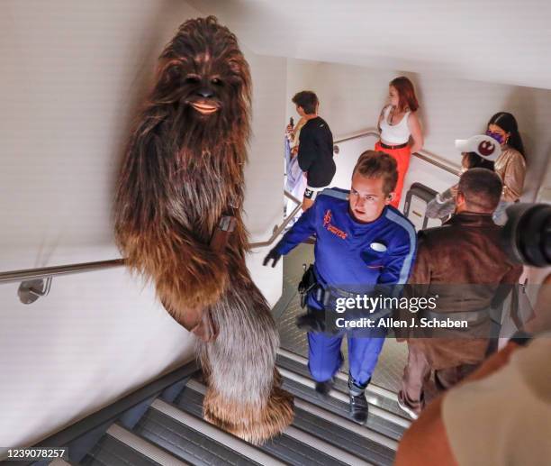 Orlando, Fla Sammie, the ships mechanic, in blue, leads Chewbacca, a legendary Wookiee warrior, as they sneak through the hallways to escape capture...