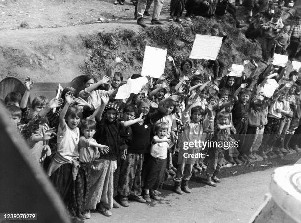 Srebrenica residents wave as Canadian UNPROFOR patrol in an armored vehicule in a street entirely destroyed by serb shelling of the Moslem enclave,...