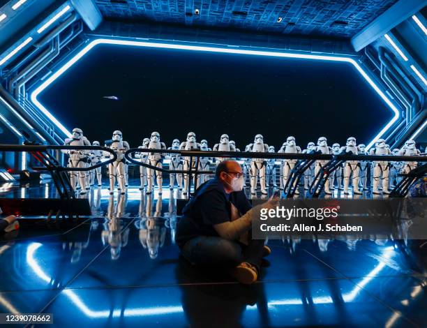 Orlando, Fla Los Angeles Times columnist Todd Martens checks his Data Pad for communication and to play games while Stormtroopers stand at attention...