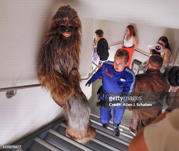 Orlando, Fla Sammie, the ship's mechanic, in blue, leads Chewbacca, a legendary Wookiee warrior, as they sneak through the hallways to escape capture...
