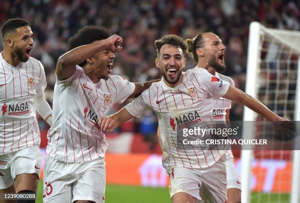 Sevilla's Spanish forward Munir El Haddadi celebrates scoring the opening goal during the UEFA Europa League round of 16 first leg football match...