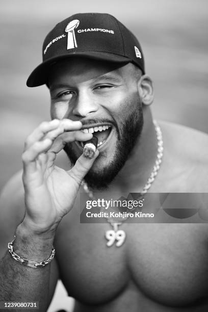 Closeup portrait of Los Angeles Rams Aaron Donald posing with cigar wearing necklace chain with his number during photo shoot outside his home....