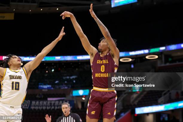 Toledo Rockets guard Ra'Heim Moss shoots as Toledo Rockets guard RayJ Dennis defends during the first half of the MAC Mens Basketball Tournament...