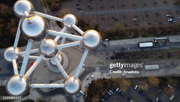 An aerial view shows a Ukrainian flag is flown at the Atomium monument during a benefit festival held for the people of Ukraine, in Brussels Belgium...