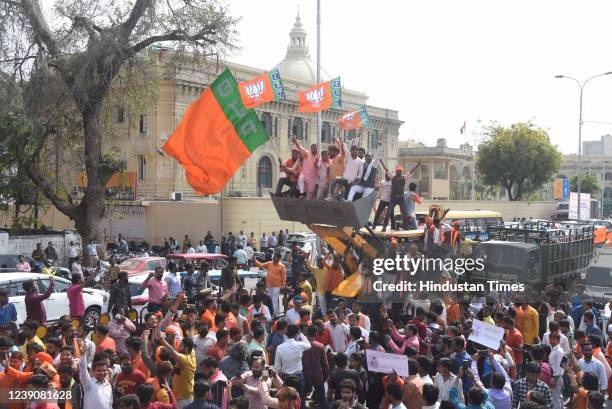 Bharatiya Janata Party supporters during the victory procession with a JCB backhoe loader to celebrate the party's lead in the Uttar Pradesh Assembly...