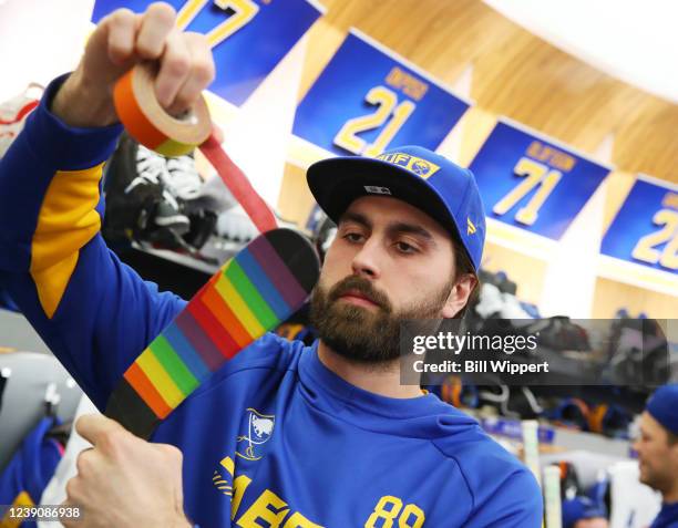 Alex Tuch of the Buffalo Sabres uses rainbow tape to prepare his hockey stick before an NHL Pride Night game against the Vegas Golden Knights game on...