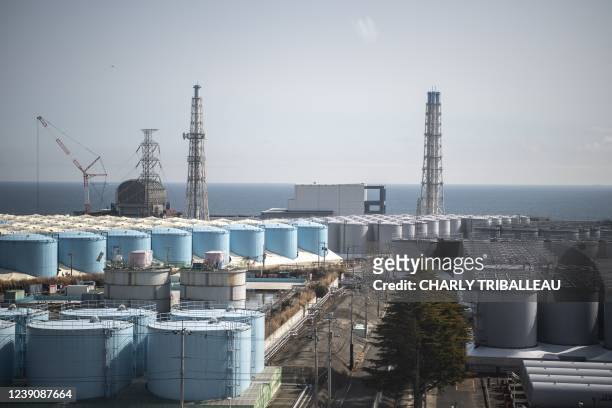 This picture taken on March 5, 2022 shows unit 3 and unit 4 reactor buildings and storage tanks for contaminated water at the Tokyo Electric Power...