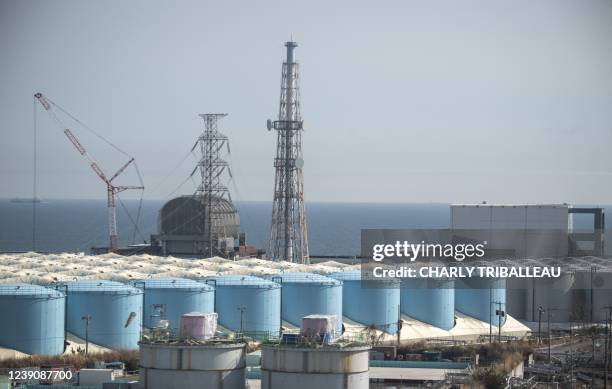 This picture taken on March 5, 2022 shows unit 3 and unit 4 reactor buildings and storage tanks for contaminated water at the Tokyo Electric Power...