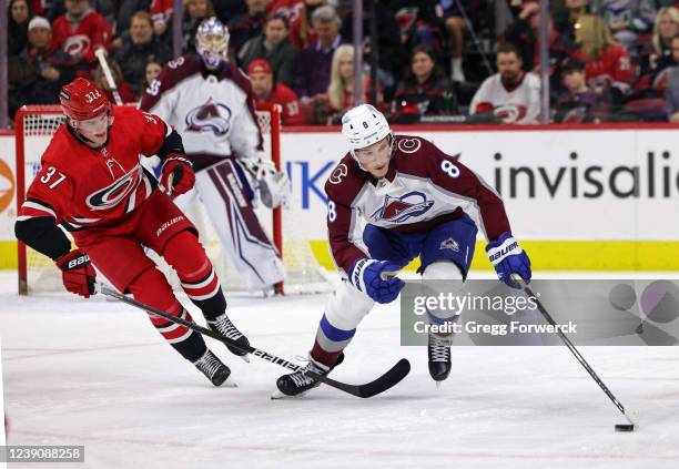 Cale Makar of the Colorado Avalanche controls the puck away from Andrei Svechnikov of the Carolina Hurricanes during an NHL game on March 10, 2022 at...