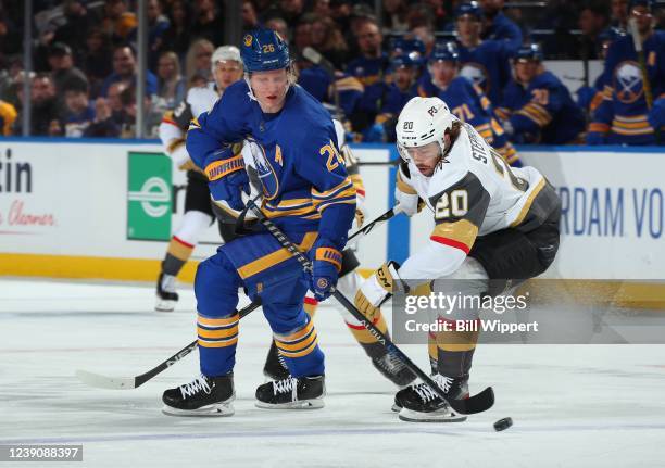 Rasmus Dahlin of the Buffalo Sabres and Chandler Stephenson of the Vegas Golden Knights battle for the puck during an NHL game on March 10, 2022 at...