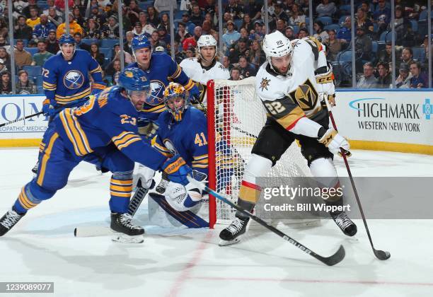 Michael Amadio of the Vegas Golden Knights is defended by Craig Anderson and Mattias Samuelsson of the Buffalo Sabres during an NHL game on March 10,...