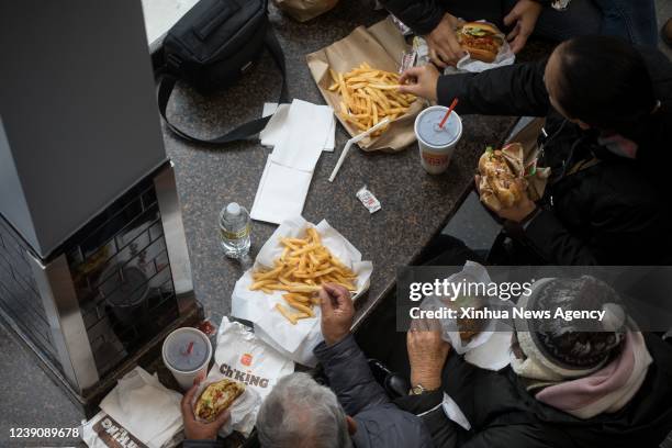 People eat at a Burger King restaurant in New York, the United States, on March 10, 2022. U.S. Consumer inflation in February continued to rise at...