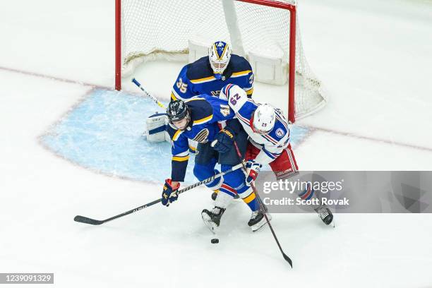 Robert Bortuzzo and Ville Husso of the St. Louis Blues defend the net against Dryden Hunt of the New York Rangers at the Enterprise Center on March...