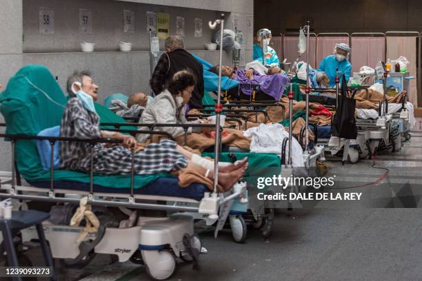 Health workers wearing personal protective equipment treats patients in a holding area next to the accident and emergency department of Princess...