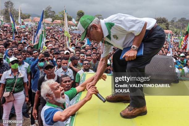 Presidential candidate and former president Jose Ramos Horta chats with former president Xanana Gusmao during an election campaign in Ermera, East...