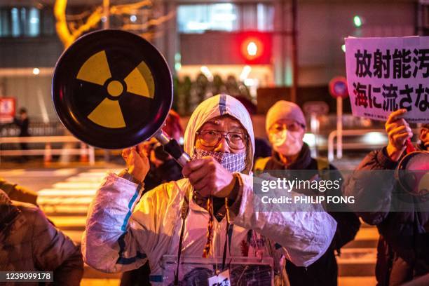 People take part in an anti-nuclear protest outside Tokyo Electric Power Company Holdings headquarters in Tokyo on March 11 on the 11th anniversary...